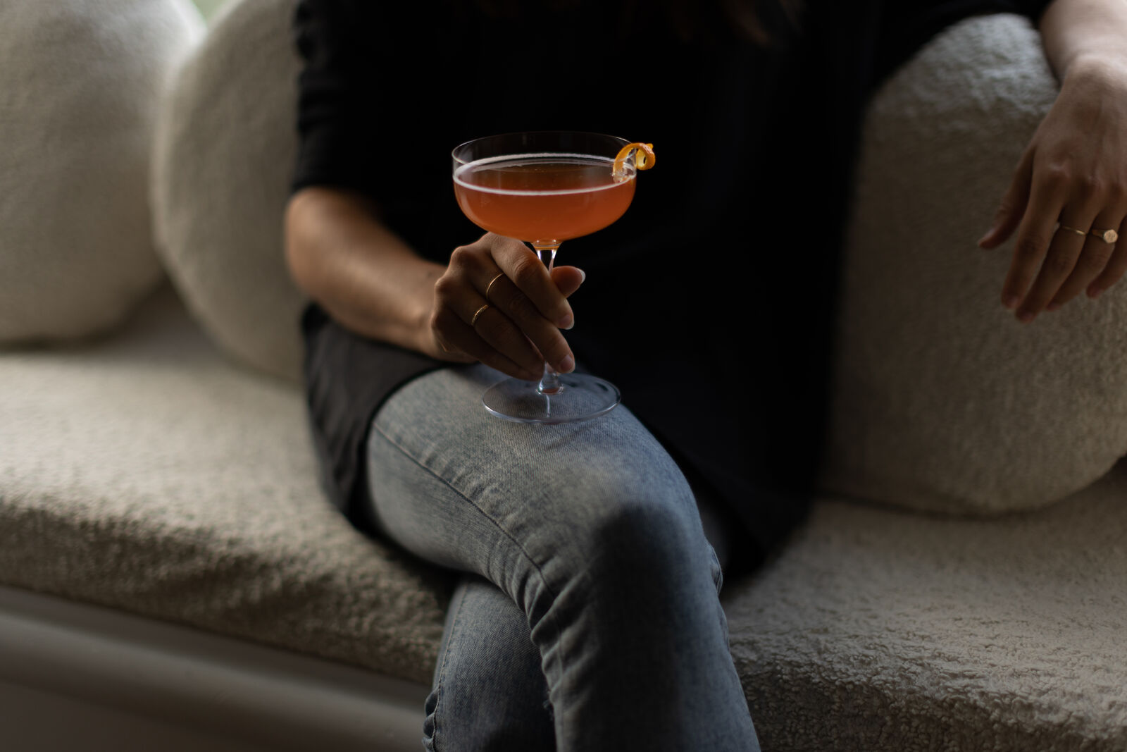 Person on couch holding glass