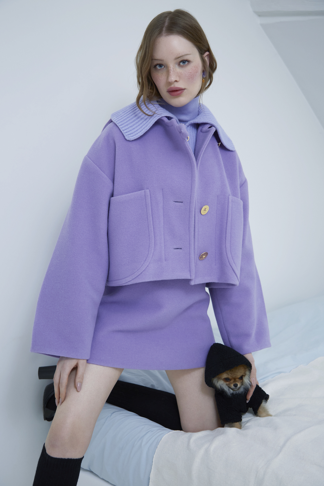 Woman in purple jacket and matching skirt
