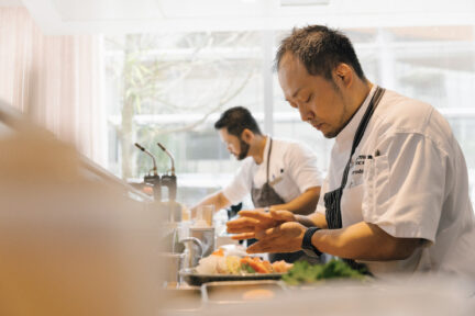 Masayoshi works with Tolentino at the raw bar.