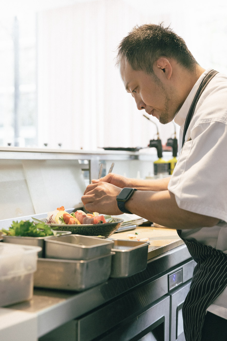 Working with fish and rice at the raw bar. 