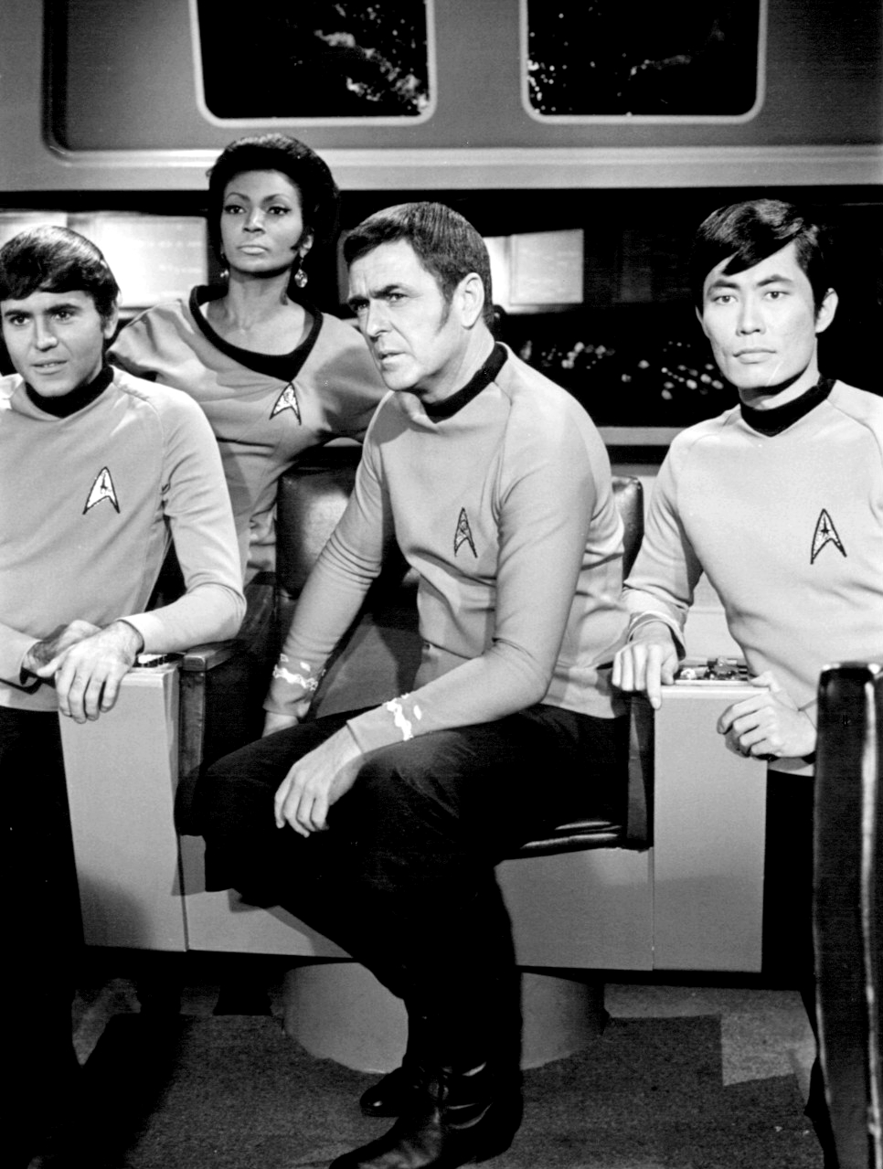 Black-and-white image of some of the Star Trek cast