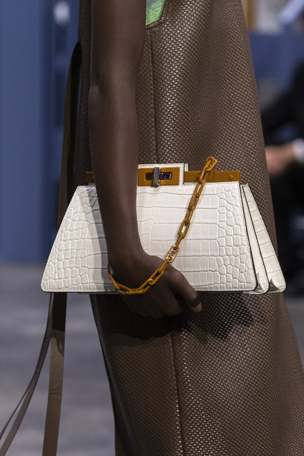Hand holding white purse