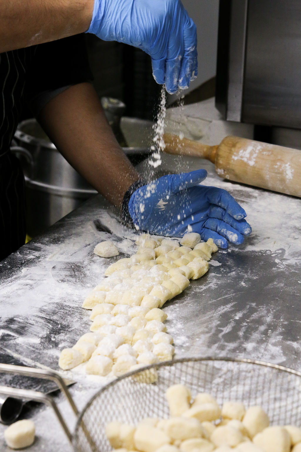 Close-up of hands working in a restaurant kitchen