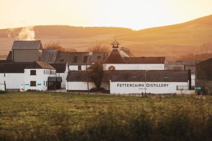 Fettercairn Distillery buildings clustered in a field.