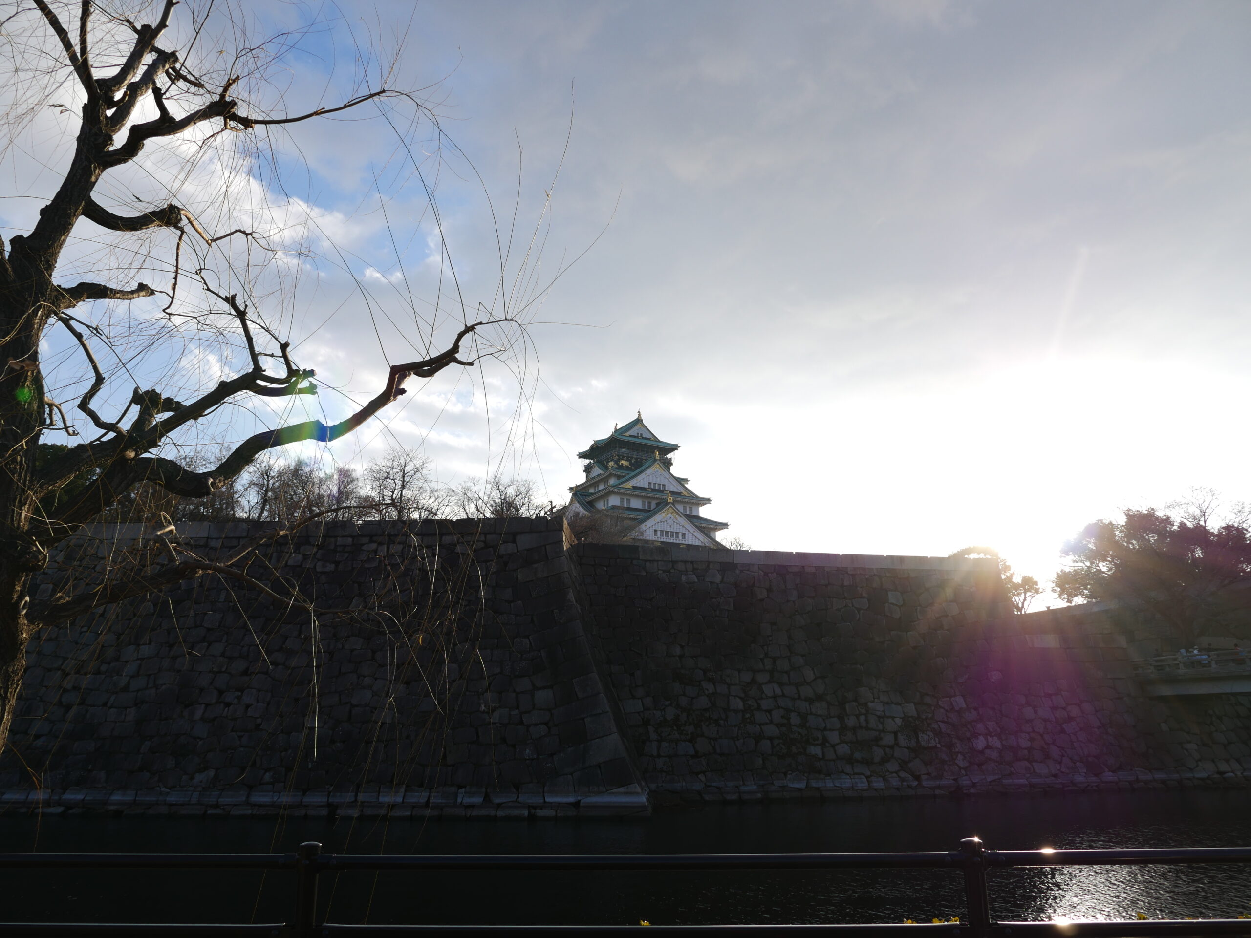 Osaka Castle, backlit and seen from below.