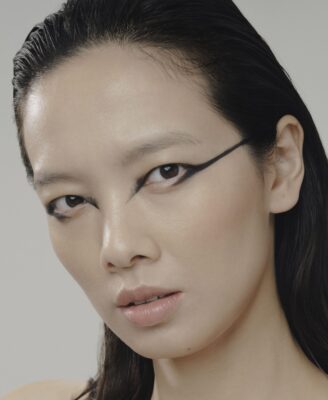 A close-up of a woman wearing black kohl eyeliner.
