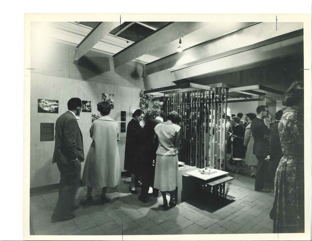 A black and white image of the Dodek home filled with visitors.