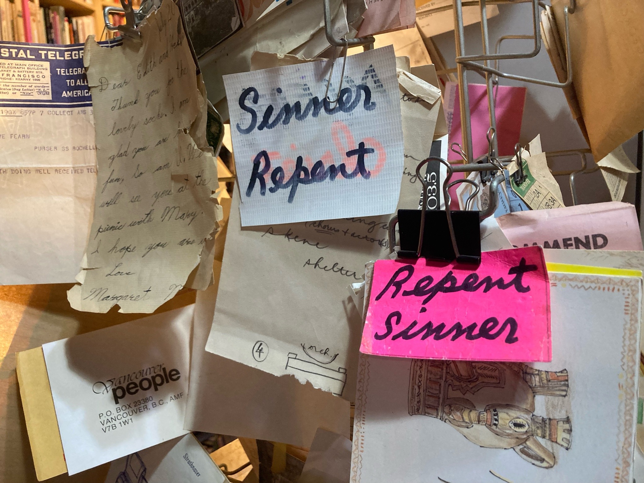 A wall of flyers, including two that say "Repent Sinner."