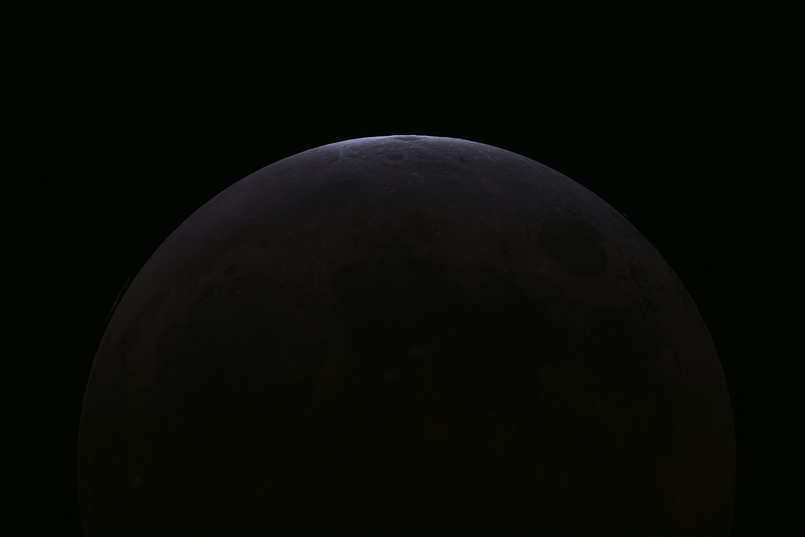 Astrophotography of the moon almost completely blocking out sunlight,