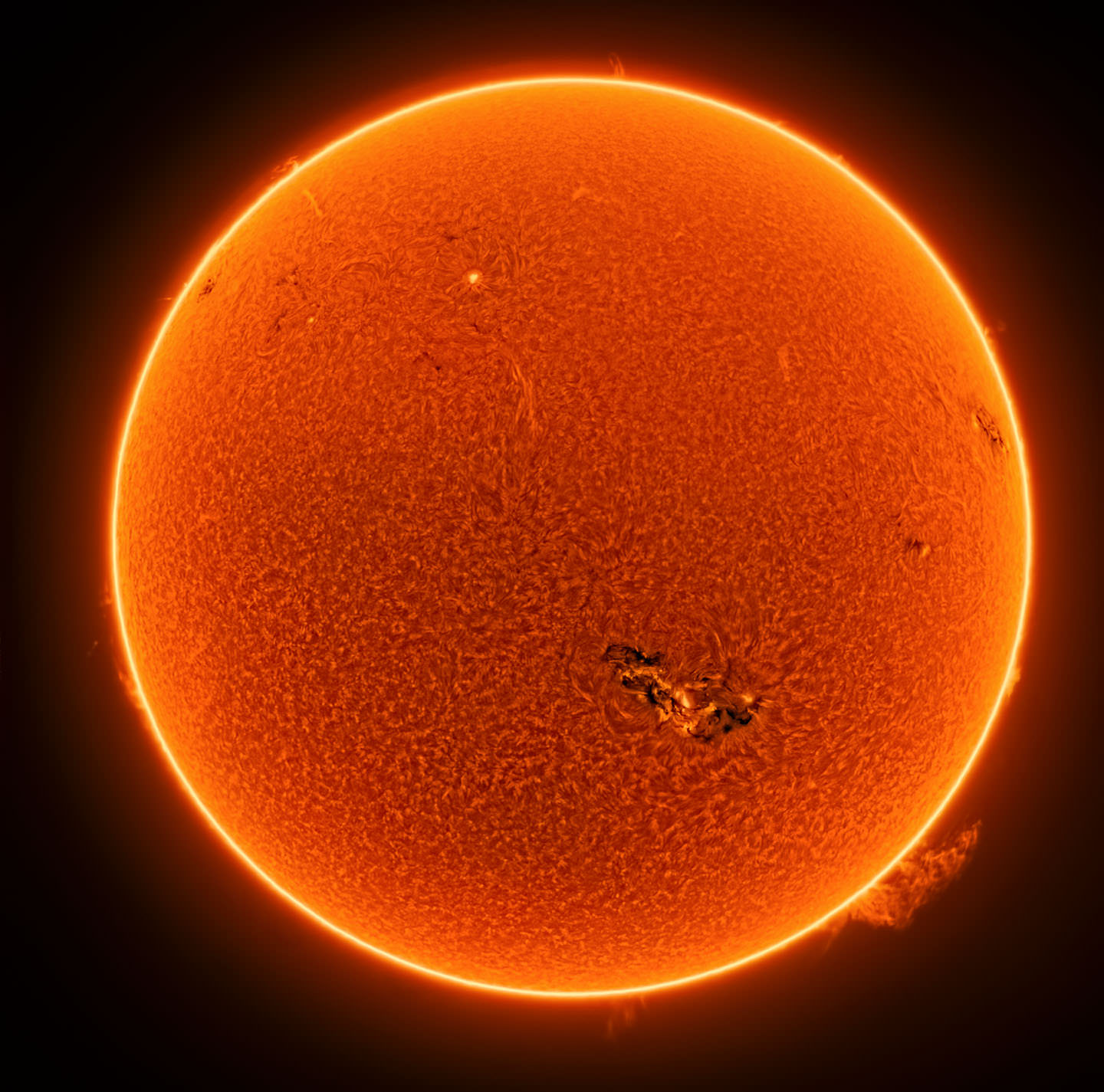 A focused image of the sun with a plasma explosion on its surface.