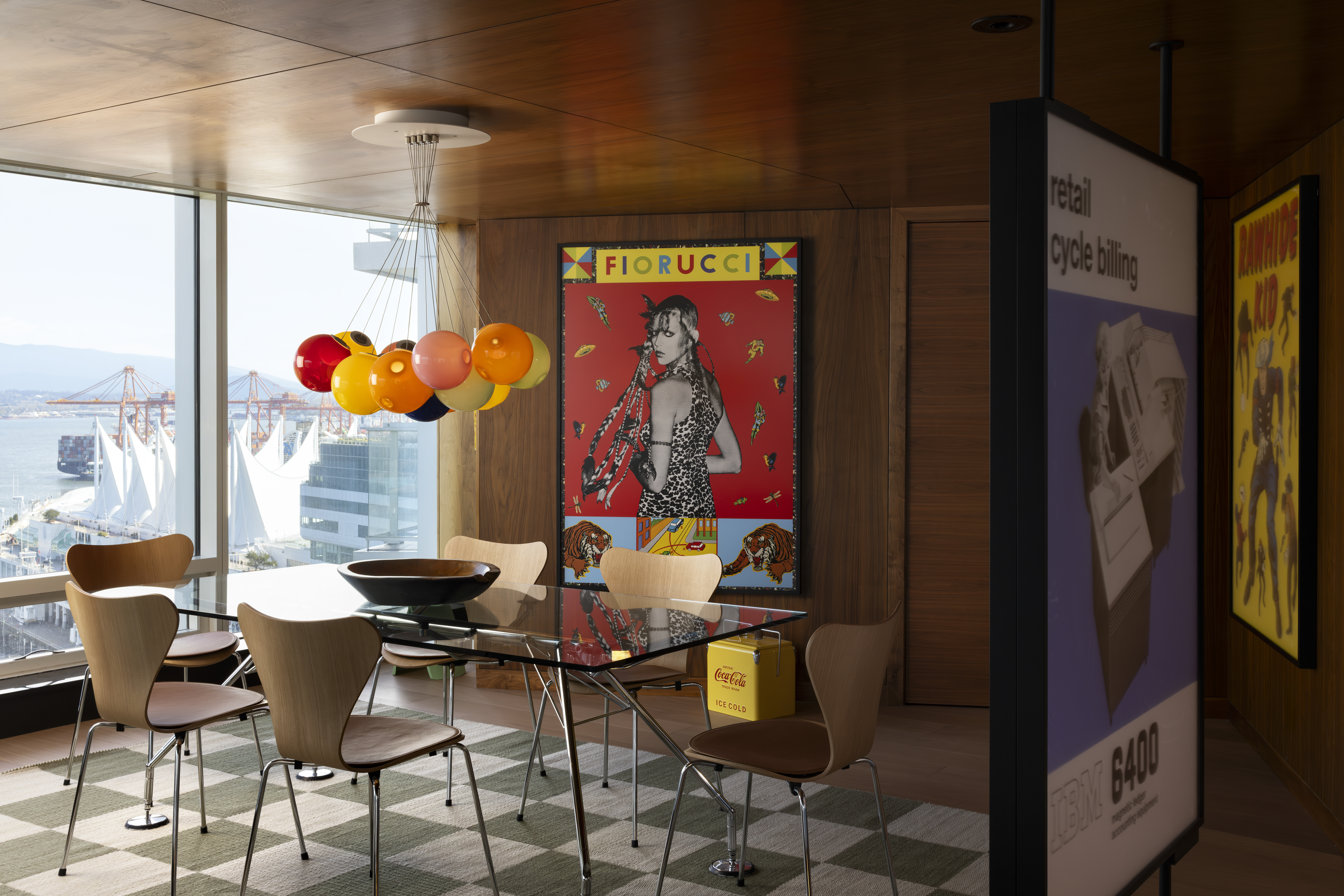 A dining room with a view of the Vancouver harbour, full of large prints in the Fairmont Pacific Rim.