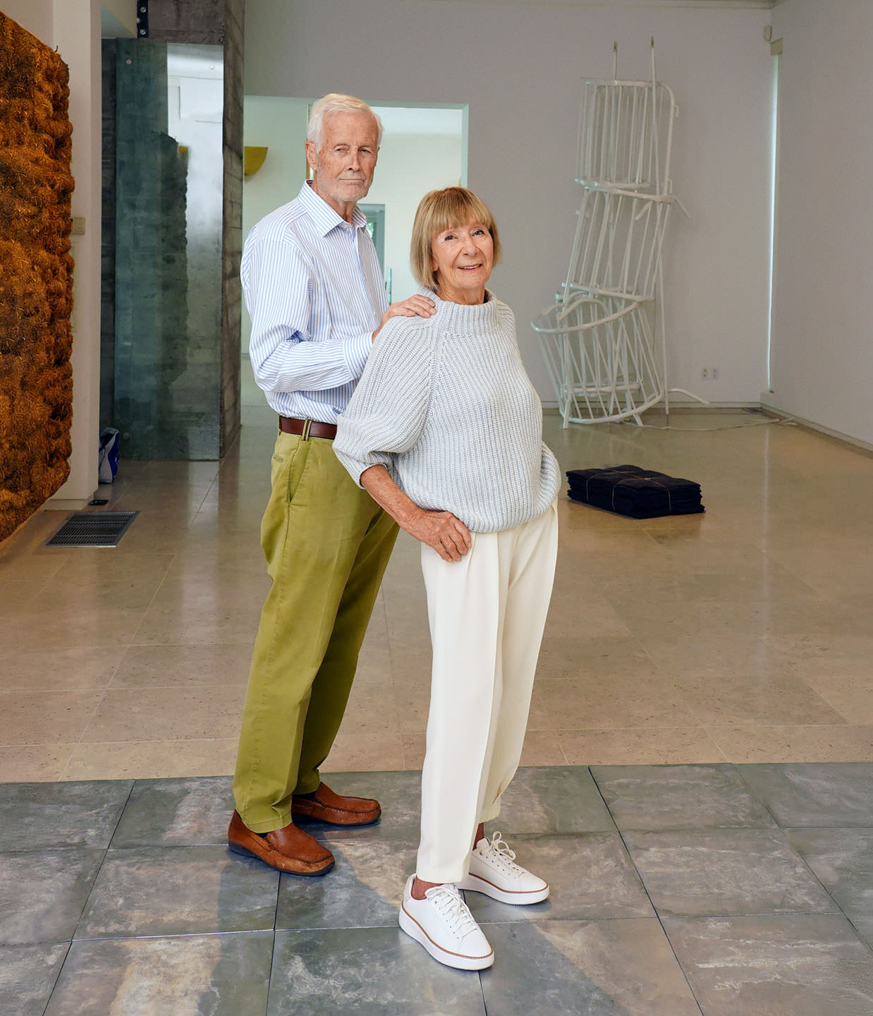 The Freybes (Brigitte and Henning) pose in their home surrounded by art.