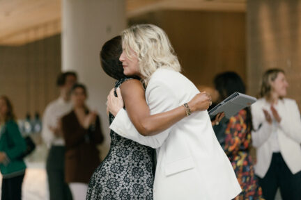 Two women hugging.
