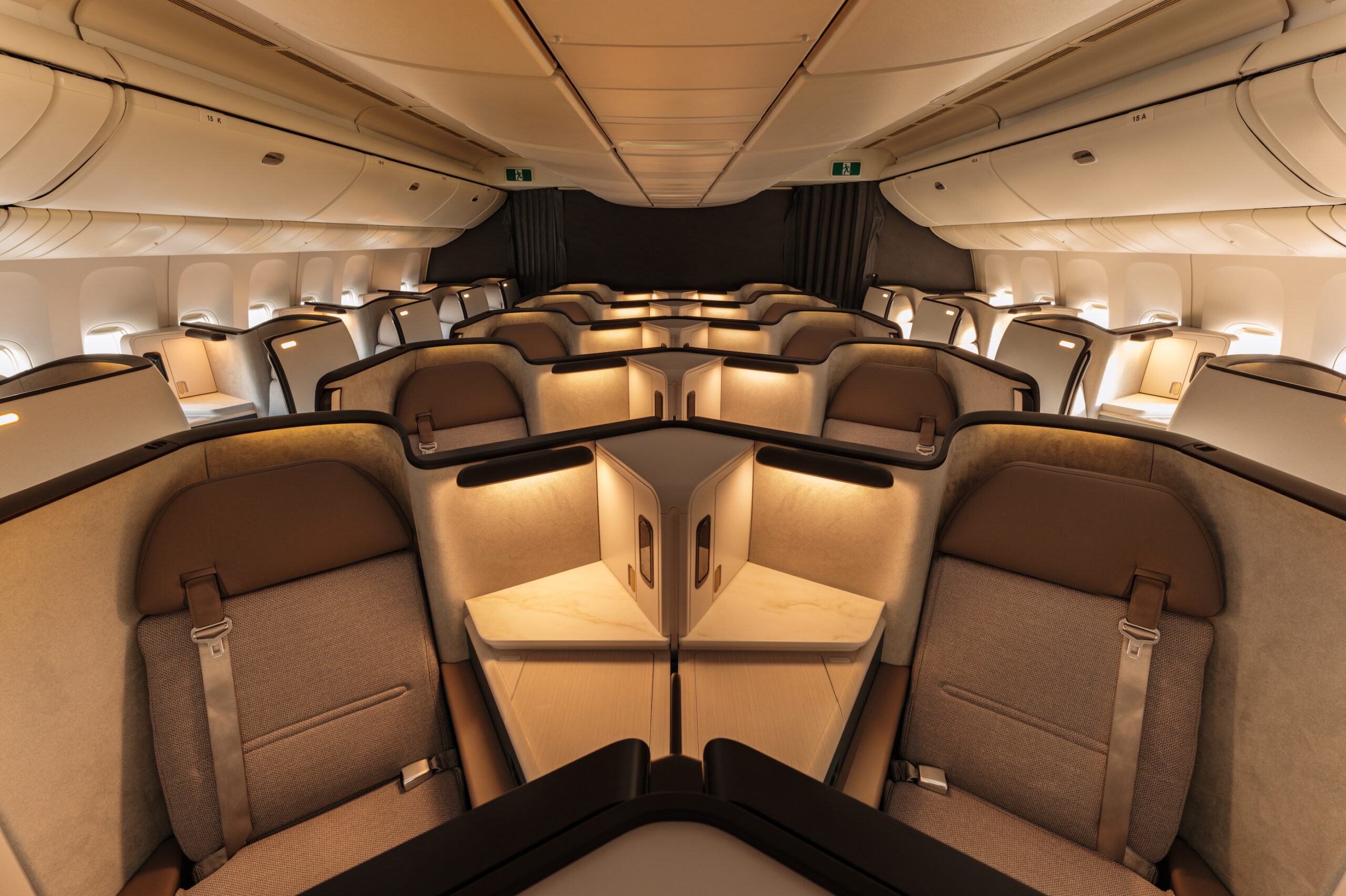 The interior of the Cathay Pacific Aria Suite, with rows of luxury travel pods inside a plane.