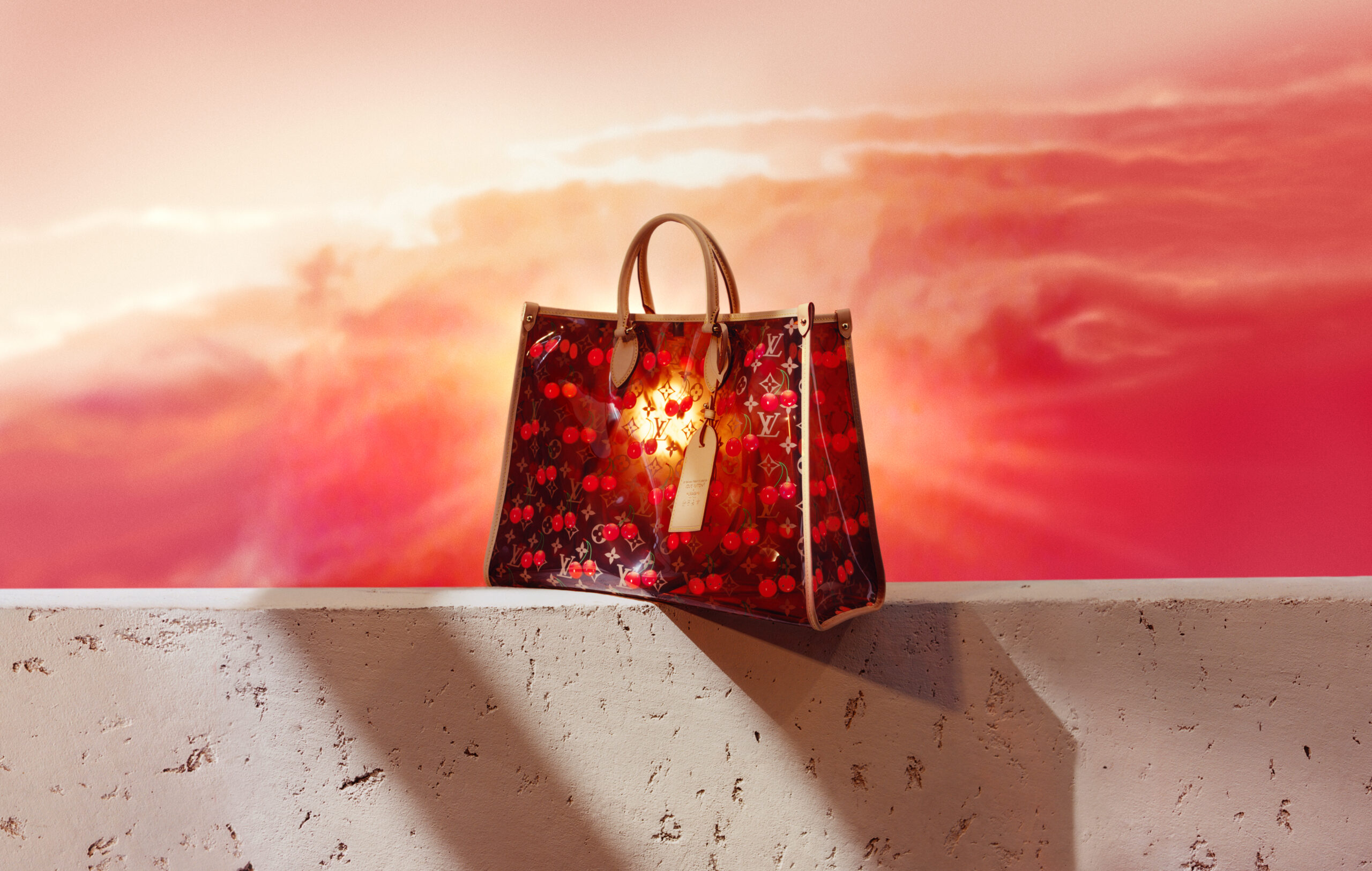 A red Louis Vuitton bag with Murakami cherries on it, for our wishlist
