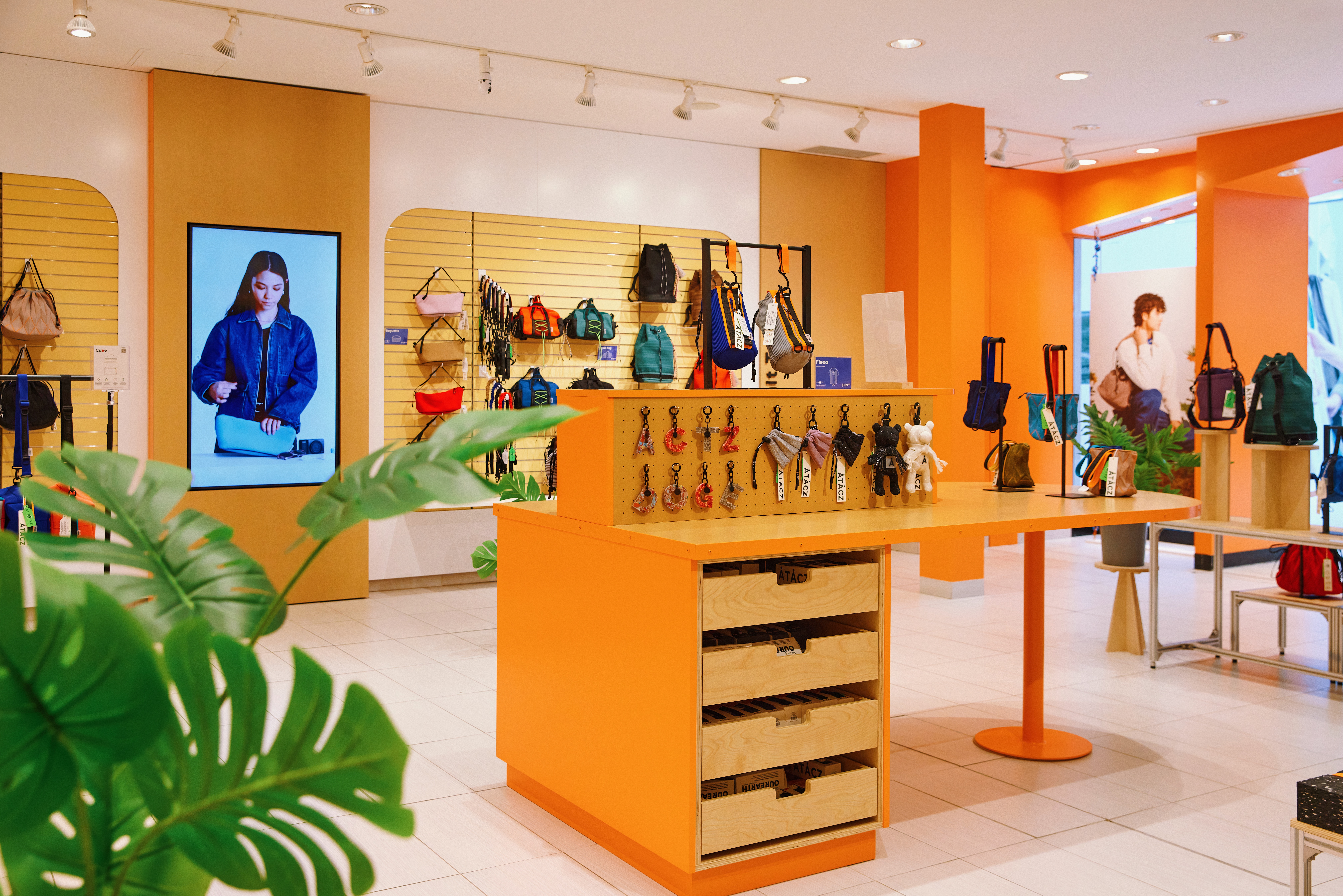 The interior of the Atacz store in Richmond, with accessories on display and bright orange walls.