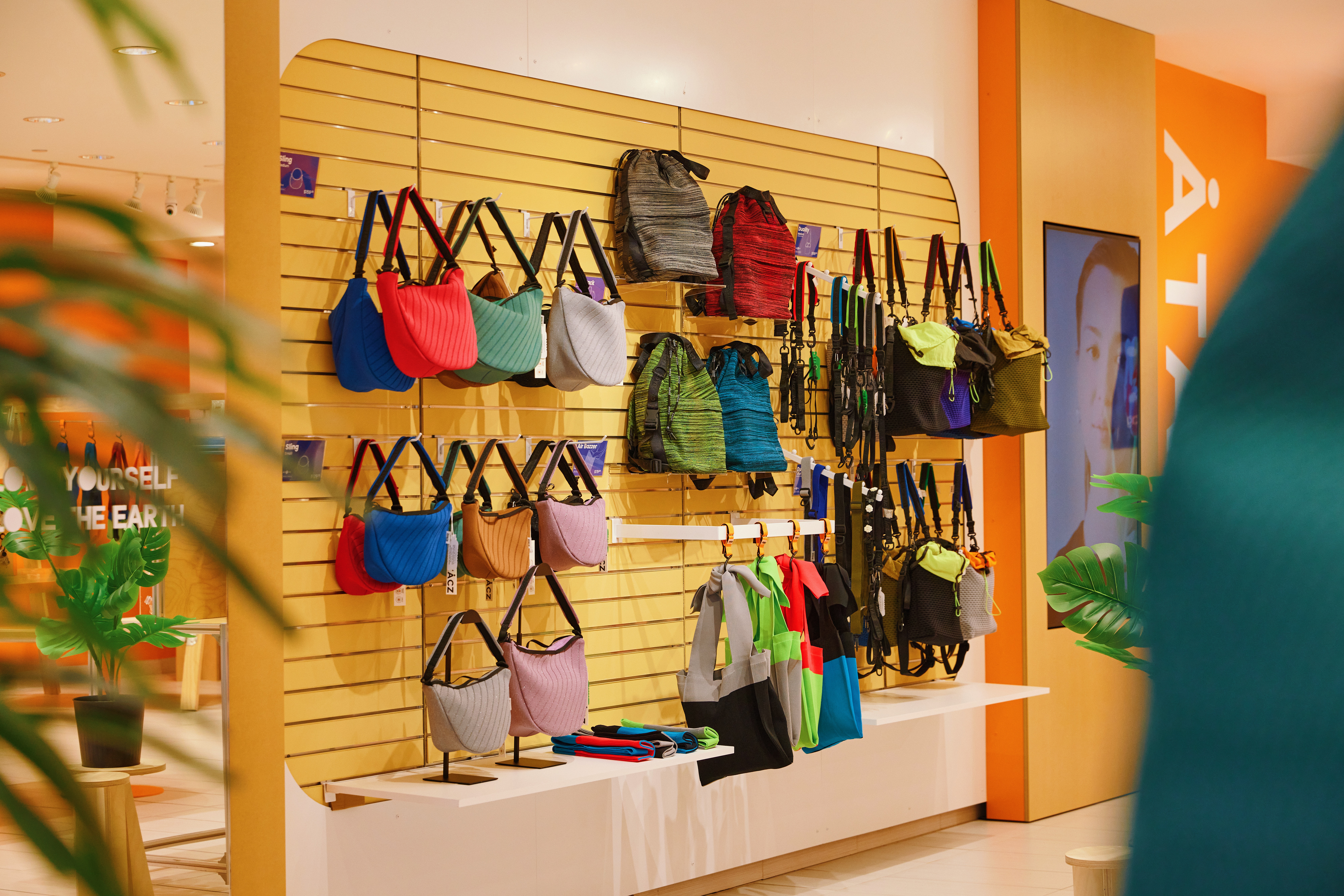 A wall display of bags in various colours.