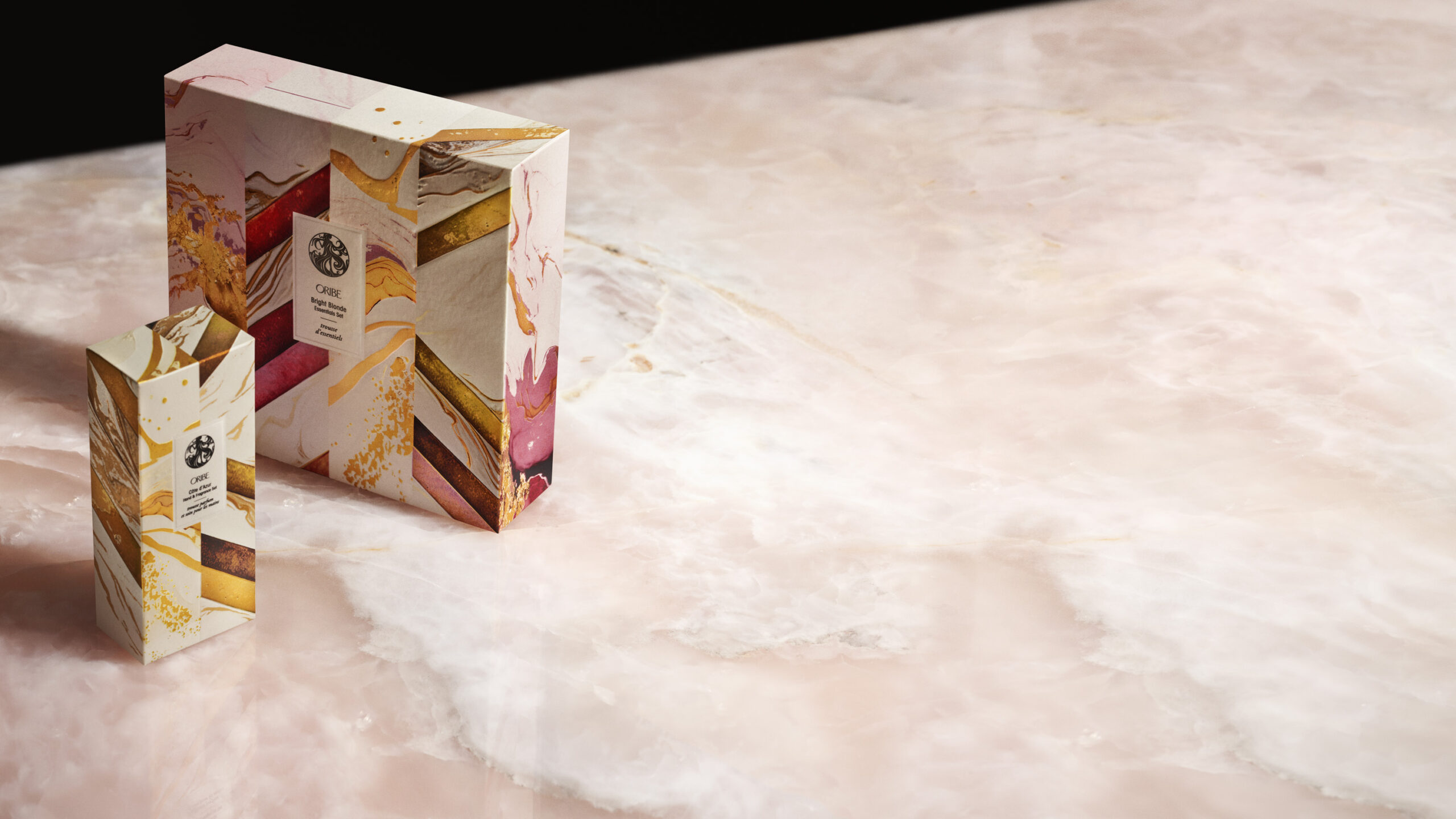 A box set of fragrances on a marble countertop, part of our July wishlist