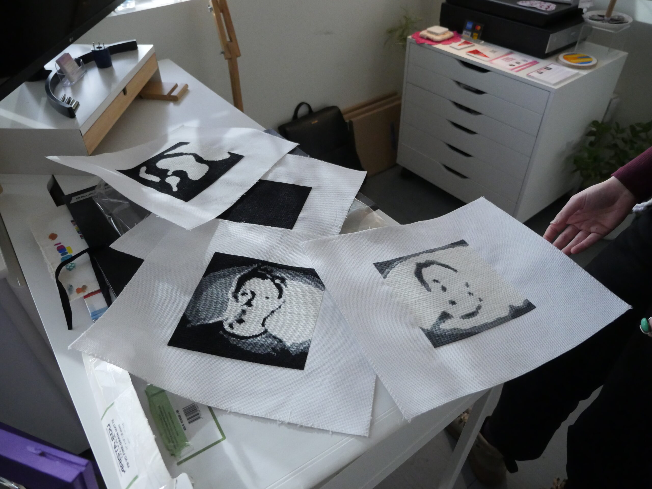 A stack of printed images of digital self portraits