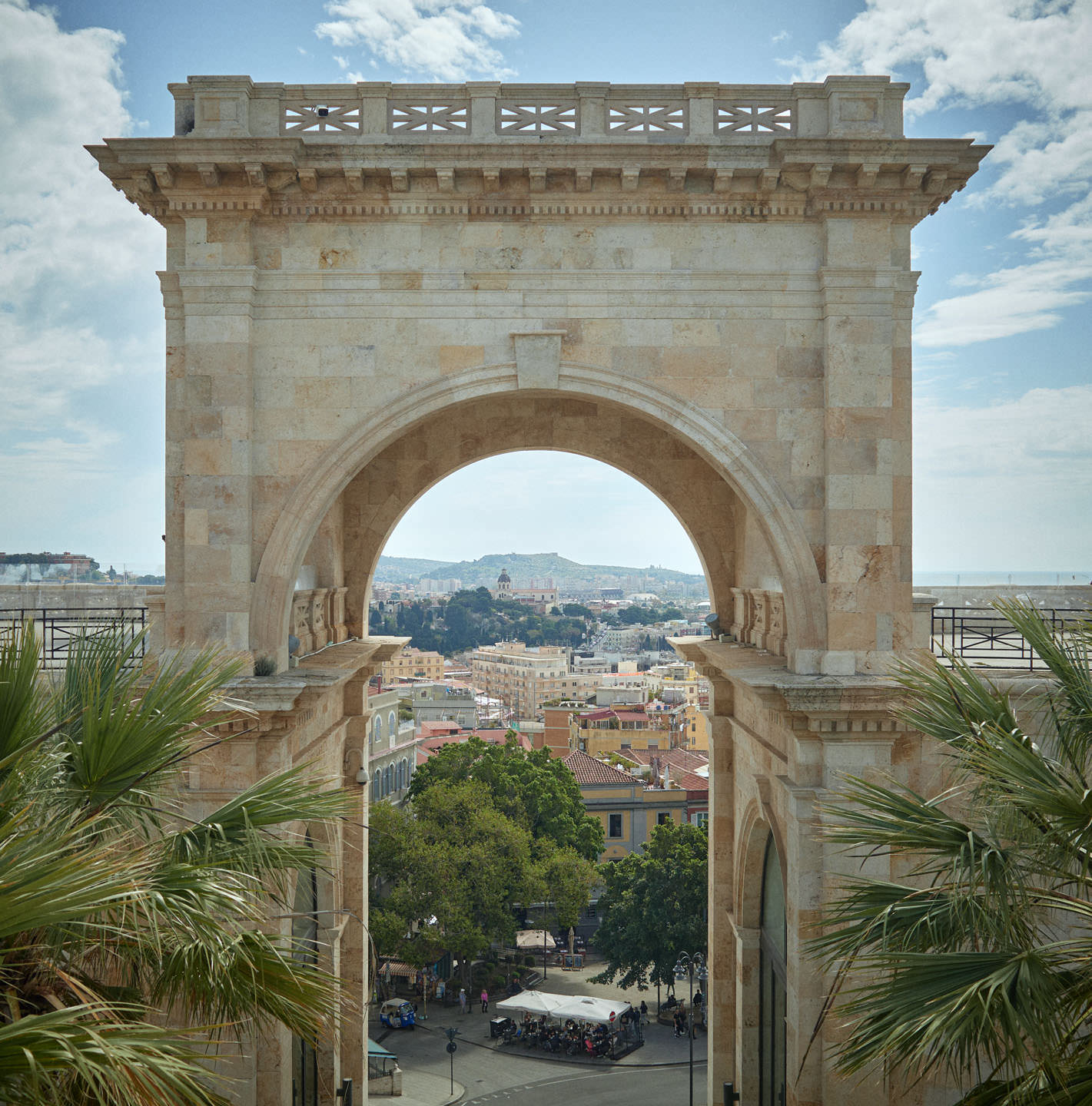 A large stone archway in a city.
