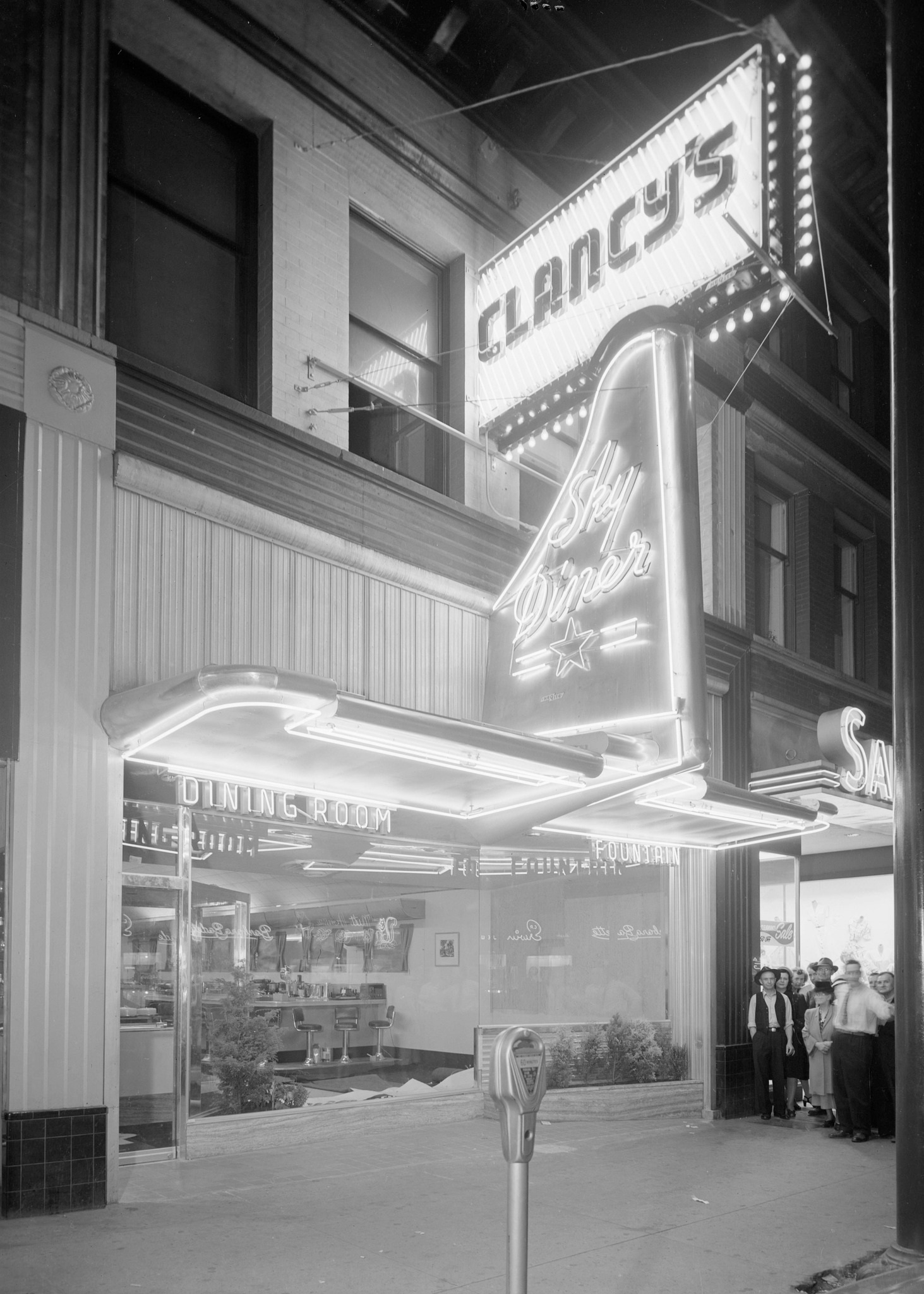 An exterior night shot of a lit sign for Clancy's Sky Diner.