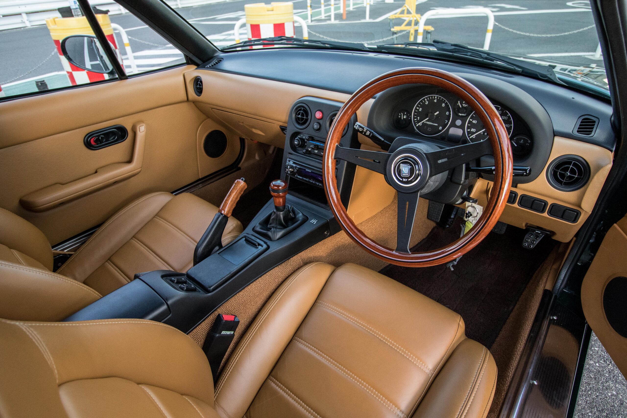 A car interior with brown leather seats.