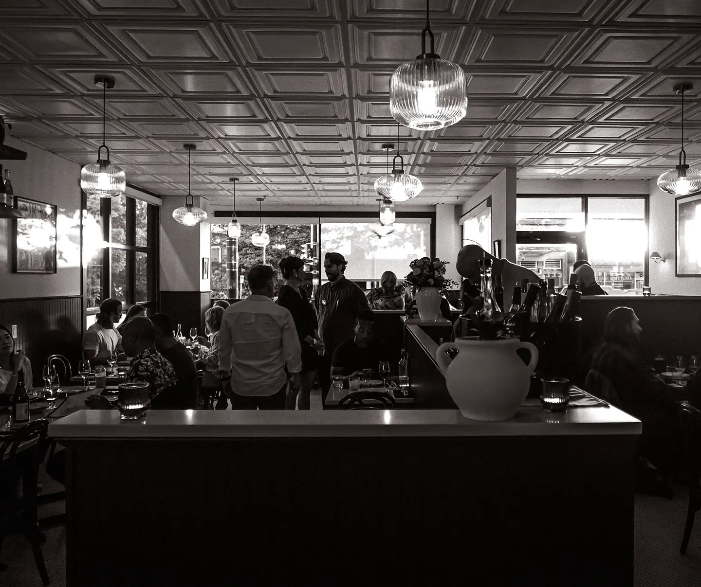 A black and white photo of a restaurant interior at Chez Céline.