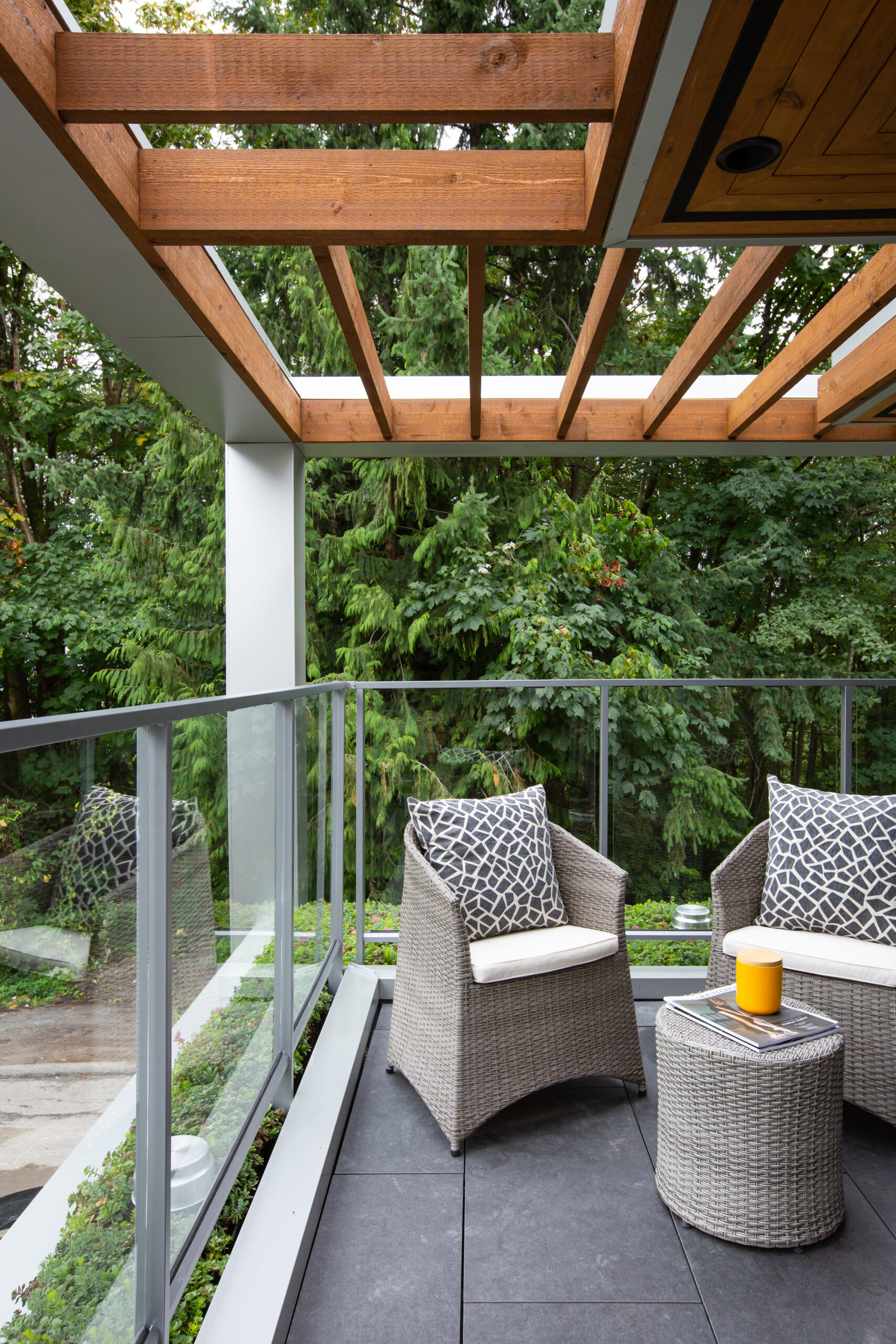 Two chairs and a small table on a second-floor patio.