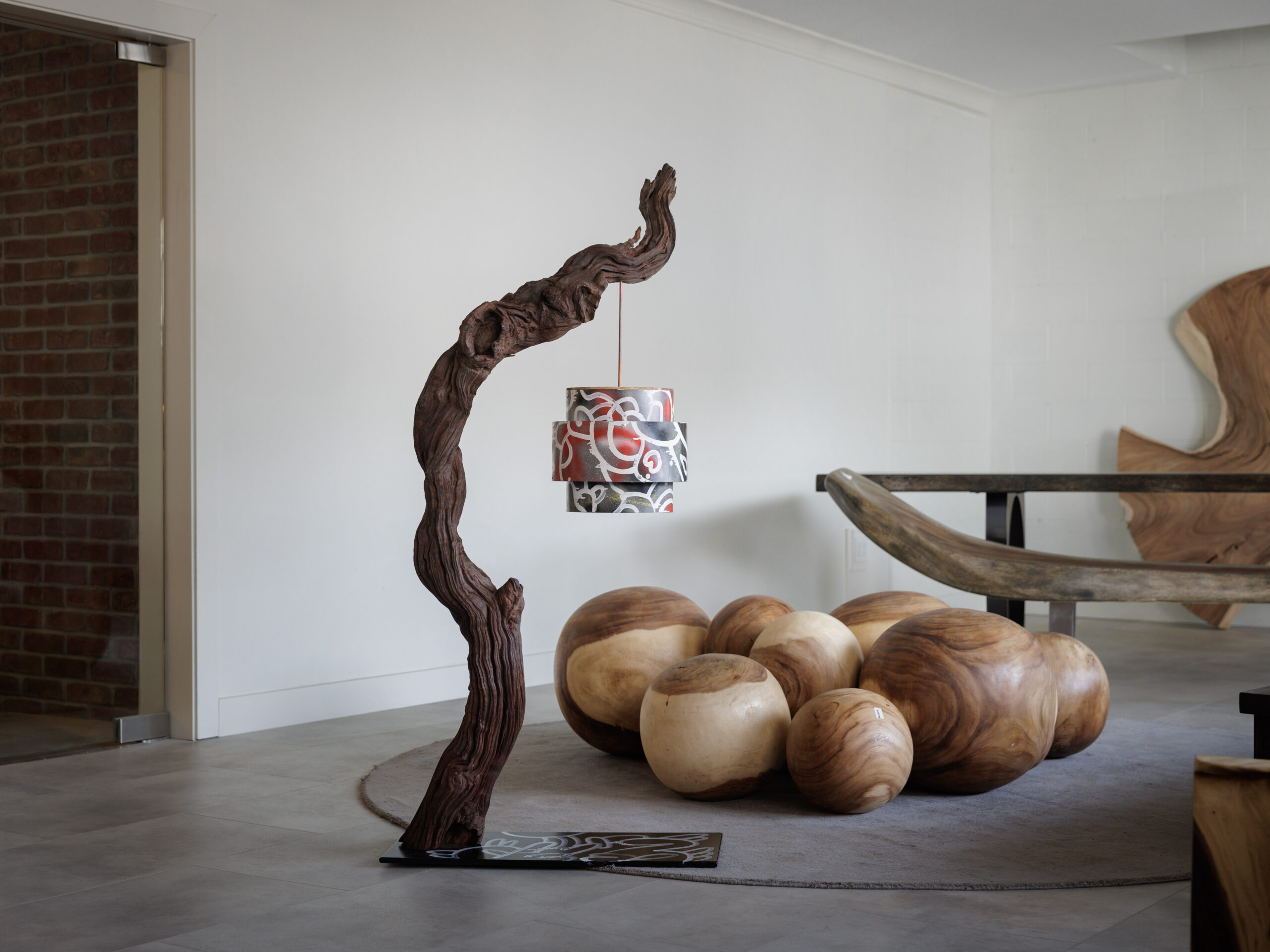 A wooden statue and lamp, sold as part of CollabWest.