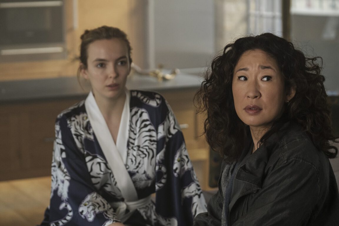 Two women, Jodie Comer and Sandra Oh, sit together.