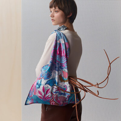 A woman carries a Hermès bag.