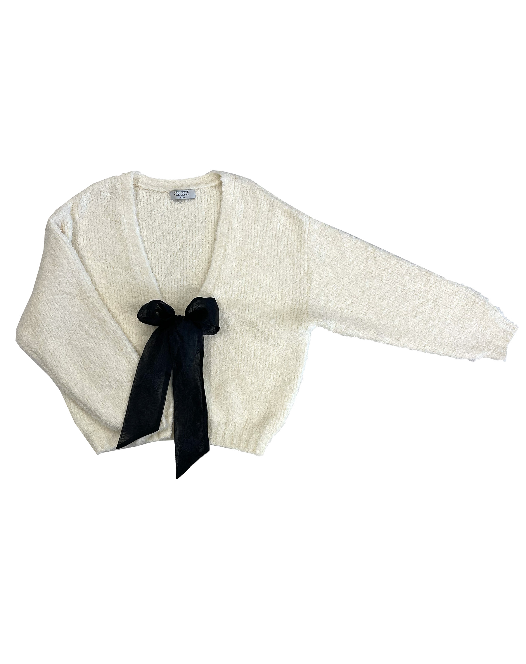 A white cardigan with a black bow - holiday gift guide.