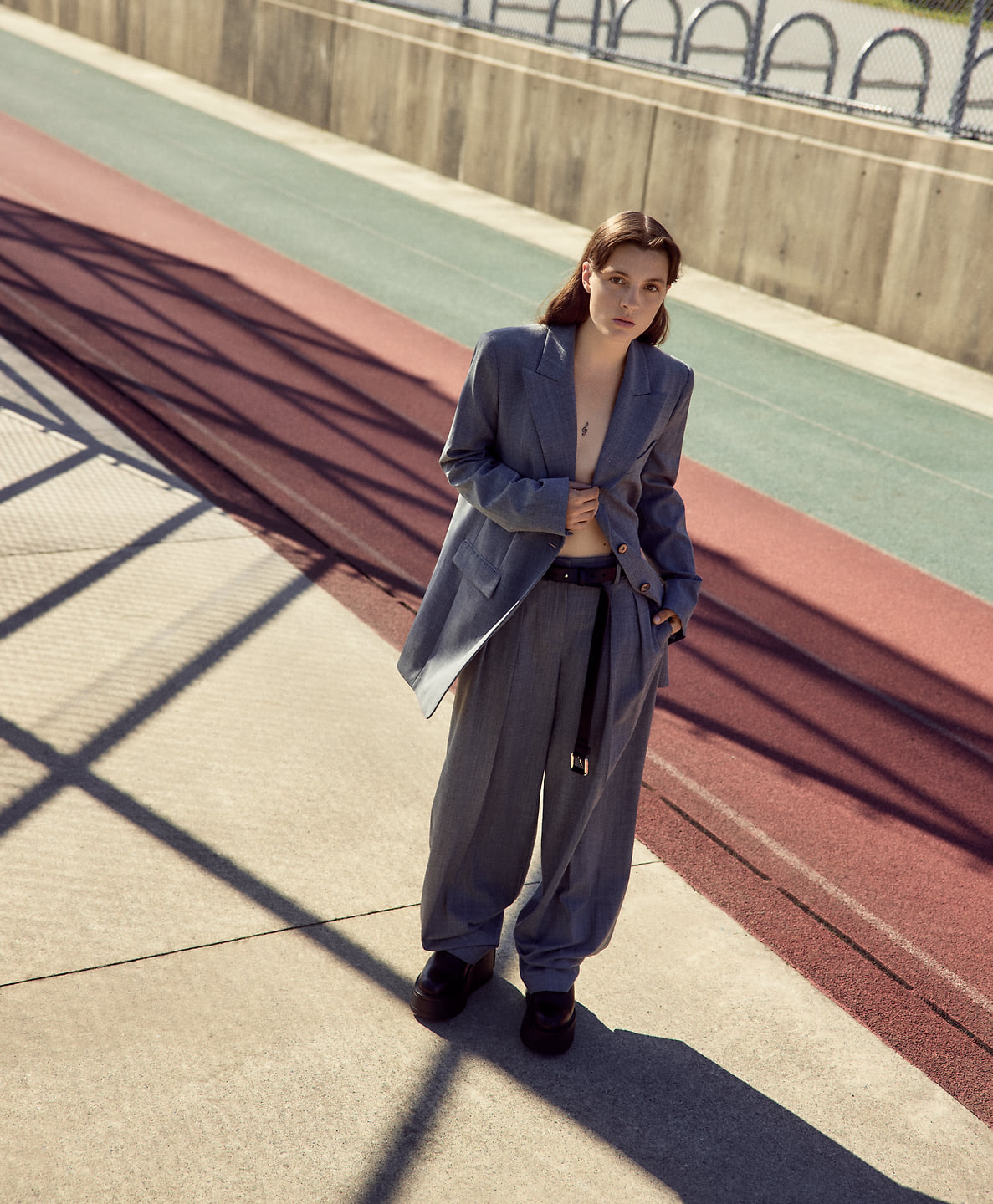 A woman poses outdoors.