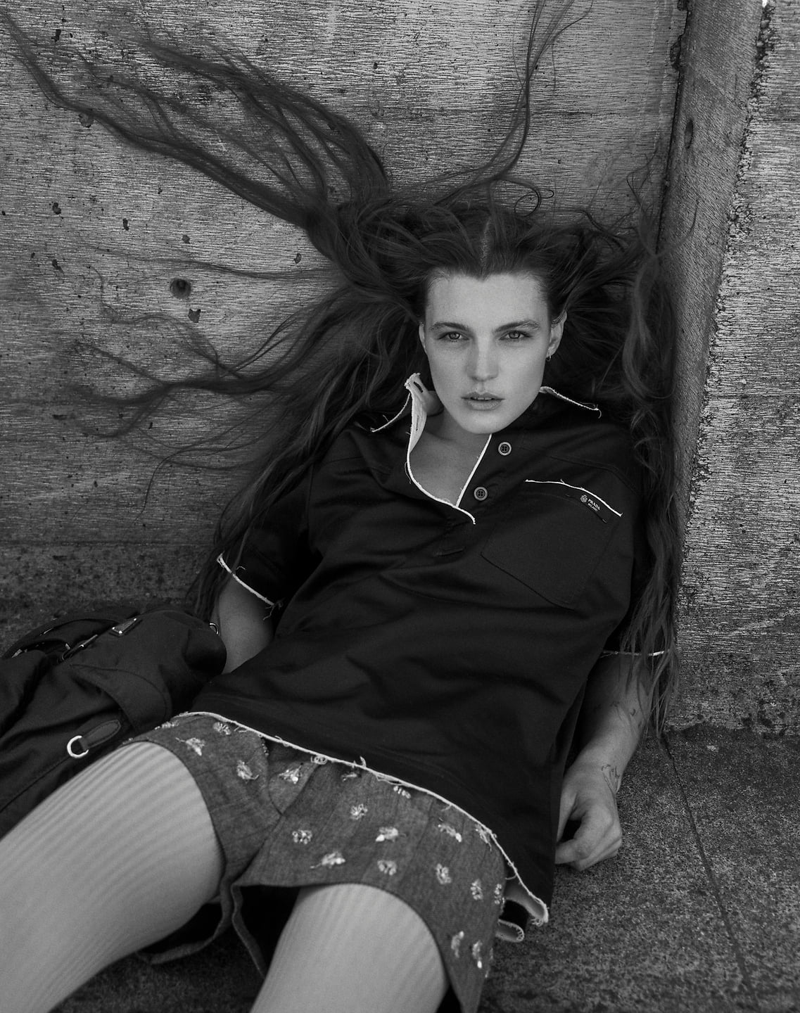 A black and white photo of Sophia Stel sitting outdoors.