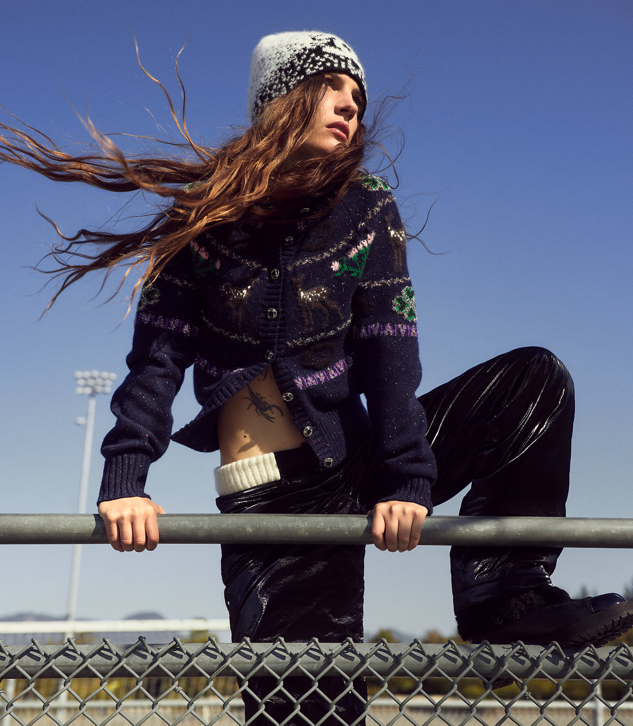 Sophia Stel poses outdoors on a fence.