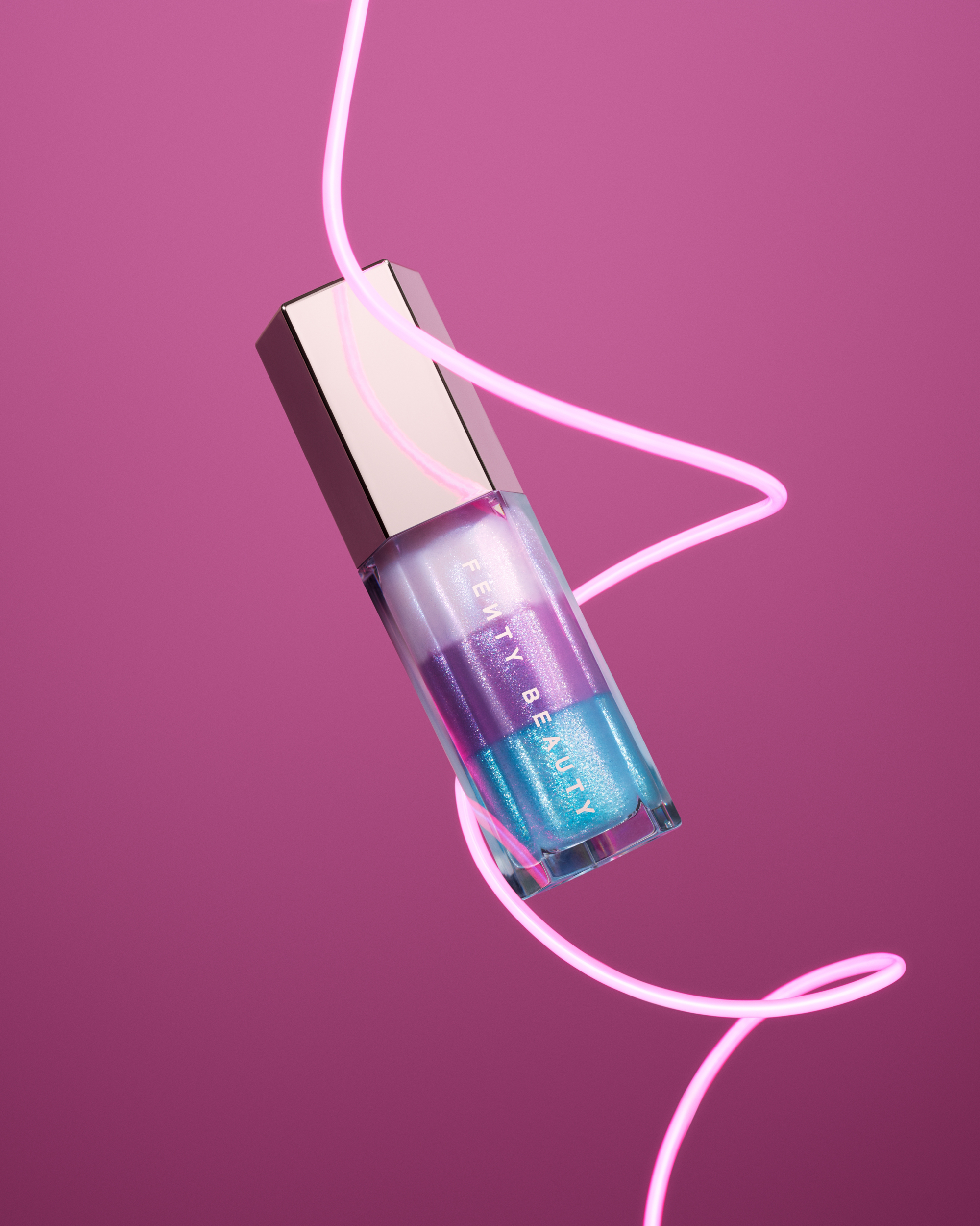 A bottle of Fenty sparkling lip gloss.