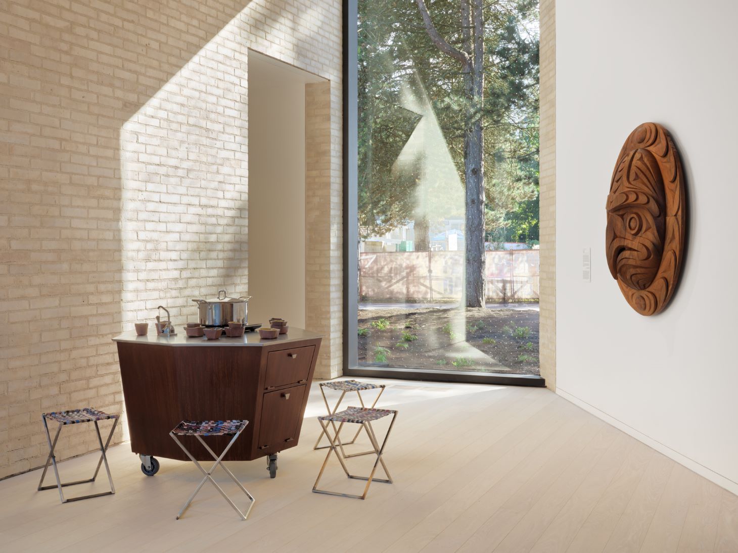 An interior shot of the Marianne and Edward Gibson Art Museum, with a window looking out.
