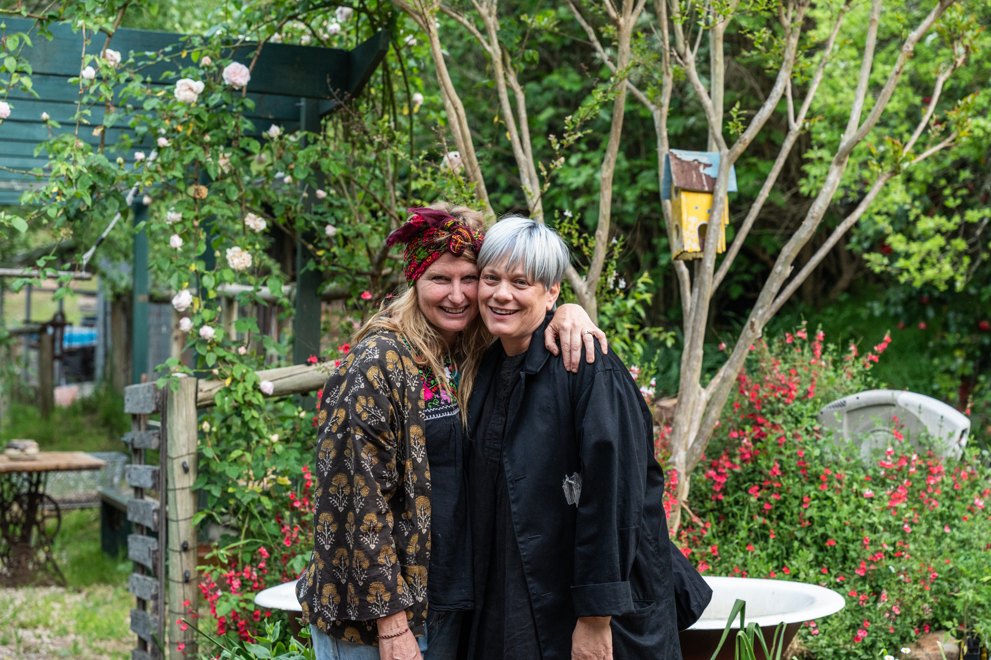 Two women, owners of Ochota Barrel and Burdock & Co, hug, facing the camera.