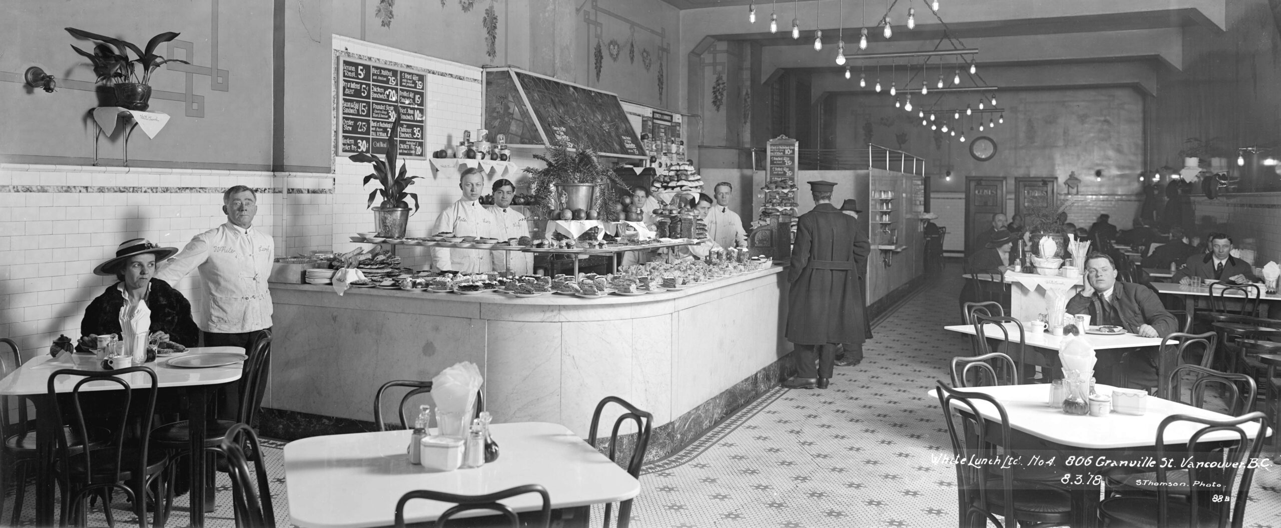 A black and white photo of a White Lunch restaurant interior.