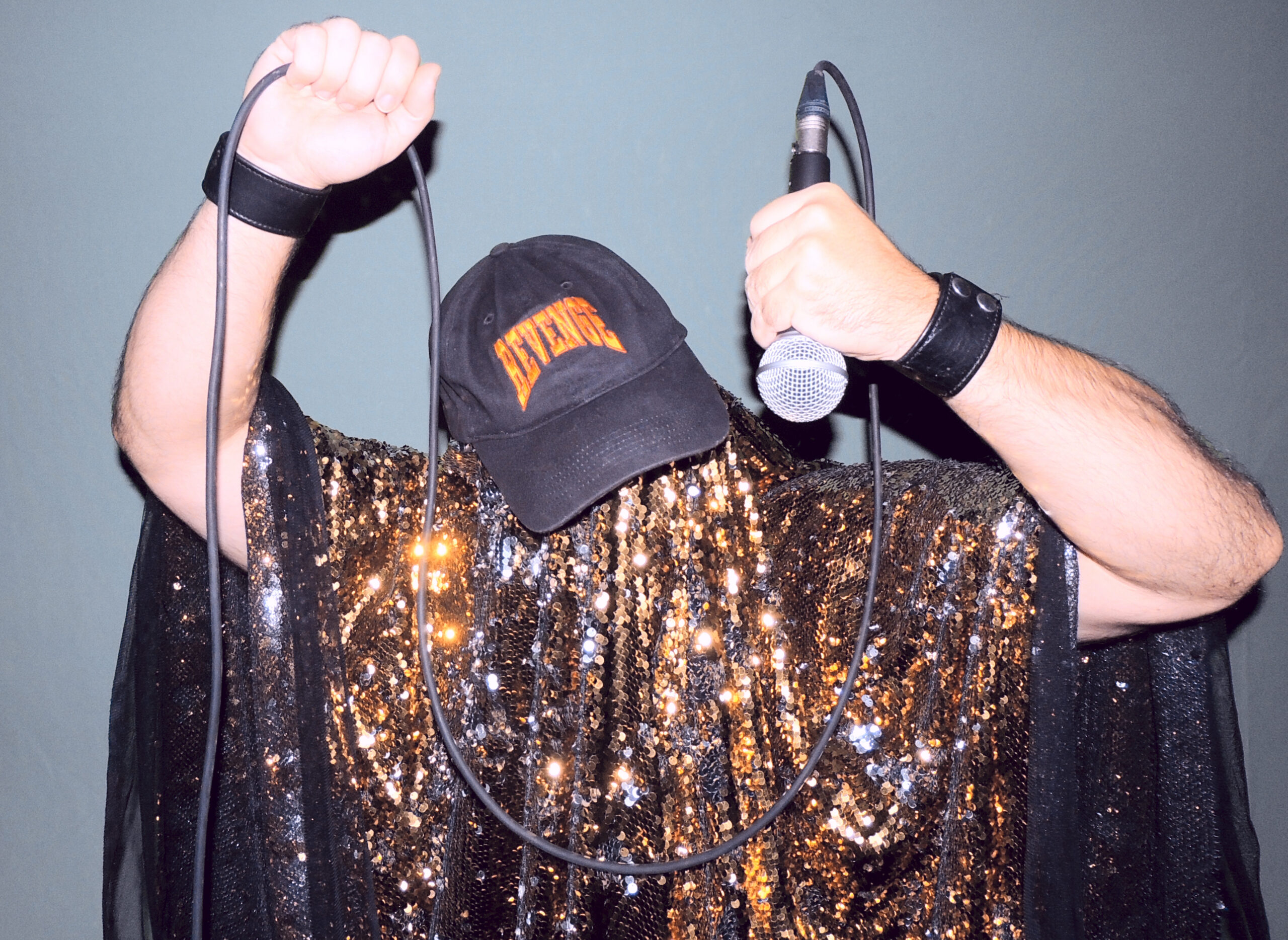 Close up of Jeff Cancade as the Golden Age of Wrestling, holding up a microphone.