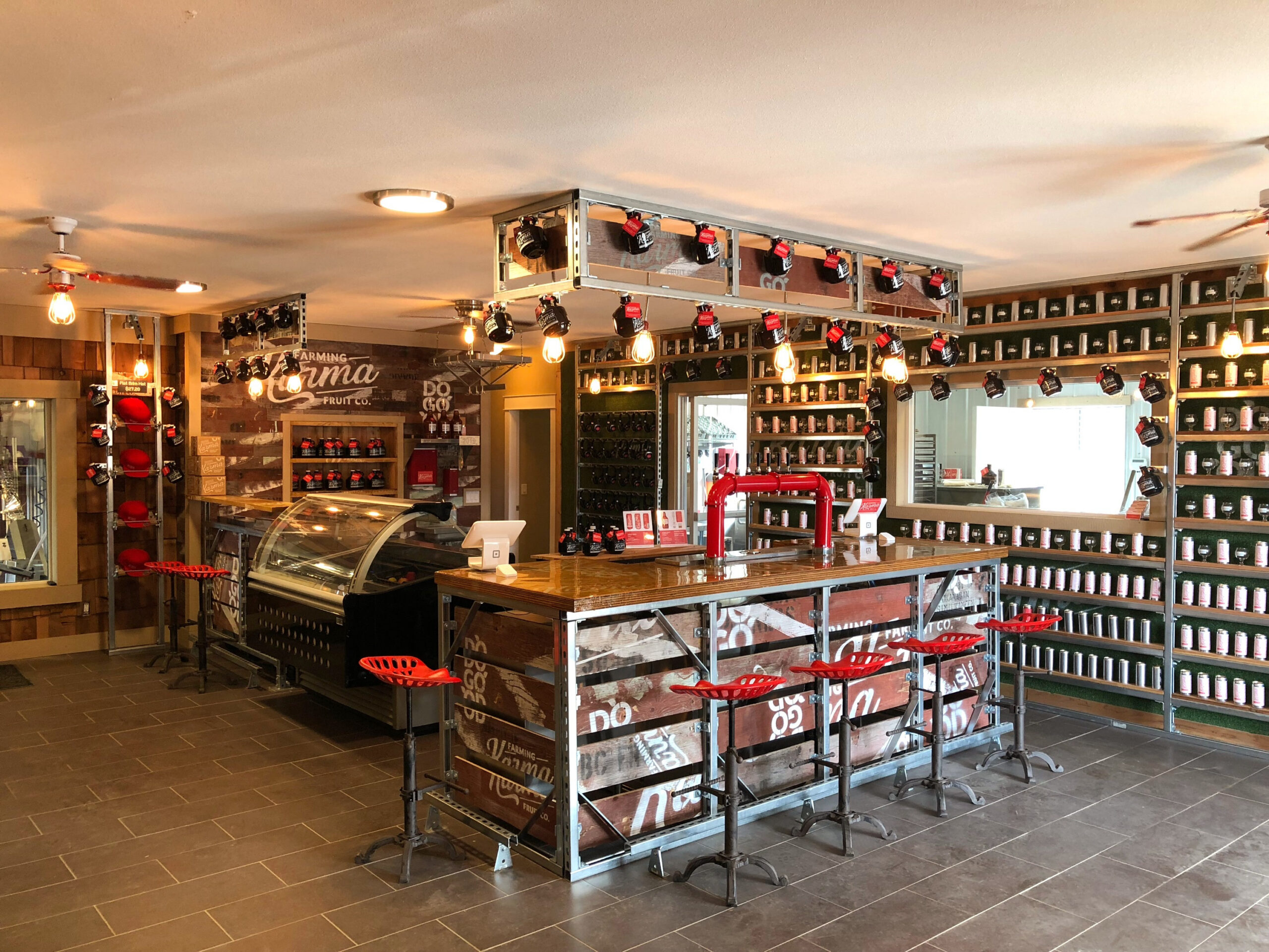 A soda tasking room with a bar and seats.