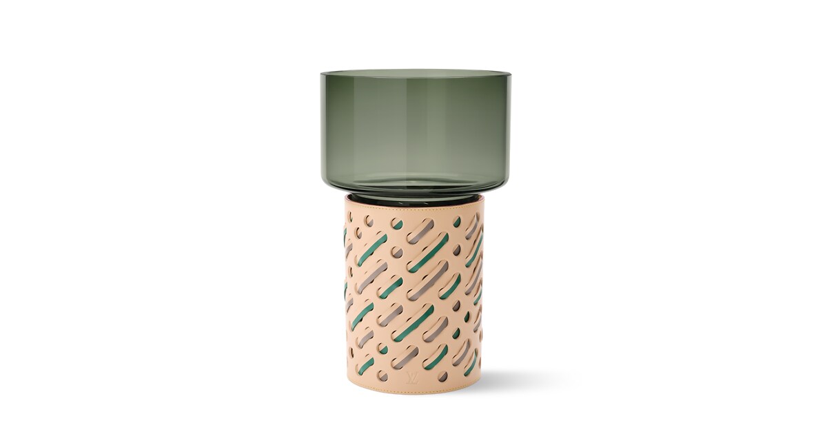 A green vase with a stylized leather base. February wishlist.