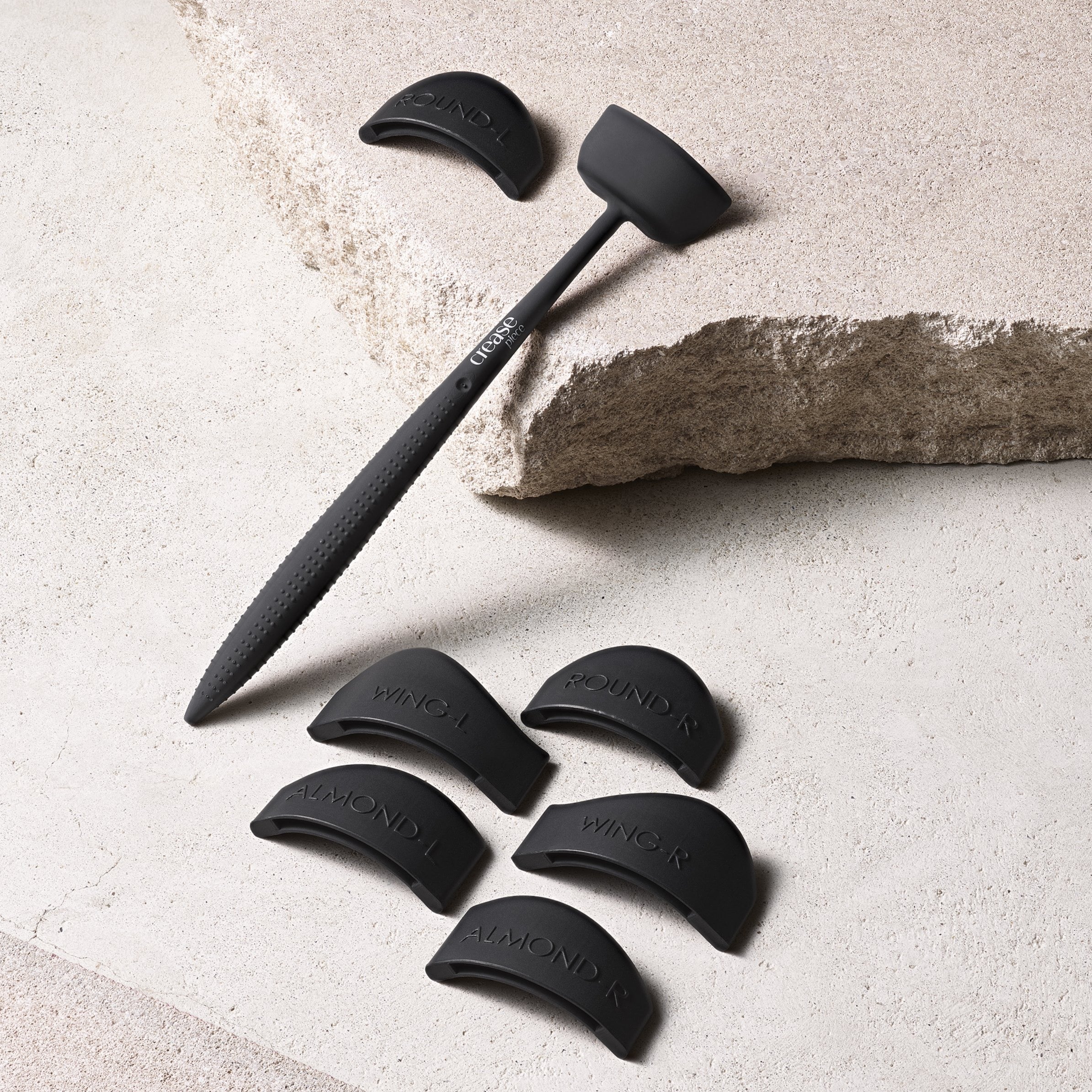 An eyelash creasing tool with six attachments.