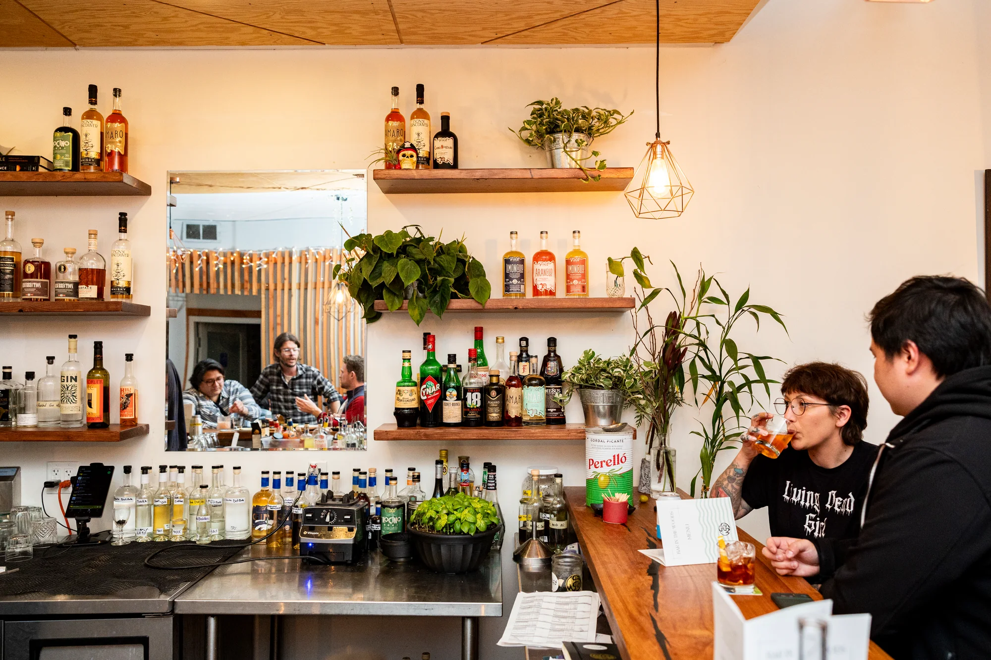 Patrons drink at a bar - The Bar in the Woods.