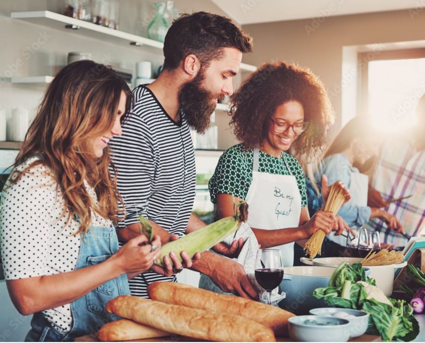 Three people cook together.